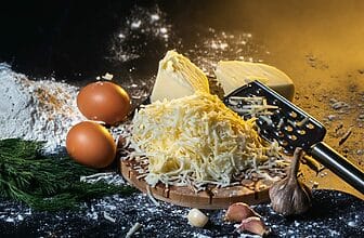 preparation of the process of cooking cheese balls with garlic and dill on a black background